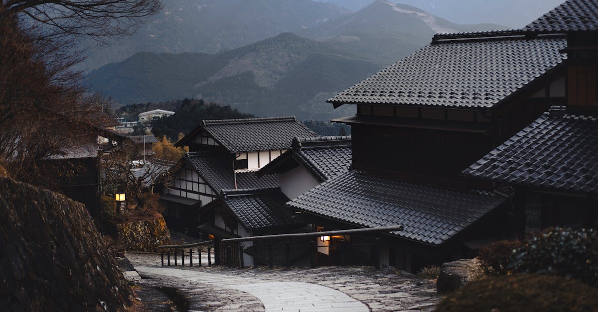 Scenic view of a traditional Japanese village nestled in the mountains during twilight.